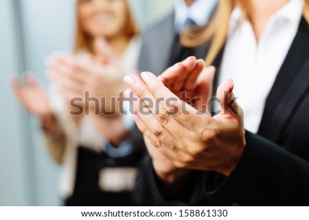 Close-up of business people clapping hands. Business seminar concept - stock photo