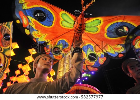 Hue, Vietnam, may 01, 2013:The celebration of Victory Day in the Vietnamese American War, street actors with fabric butterflies in the hands of a street procession, Hue, Vietnam