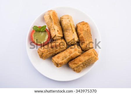 veg roll in white dish with mint leaf, isolated on white background, top view