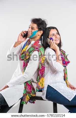 stock photo indian married couple holi festival chatting phone stock photo indian married couple holi festival chatting phone