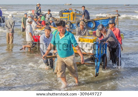 VUNG TAU, VIETNAM - AUG 23,2015: Fishermen on beach at the Fishing Village Long Hai, Vietnam.