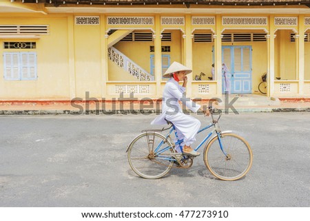 TAY NINH, VIETNAM - NOV 10, 2014:Cao Dai temple area and meditating followers of the Cao Dai religion in the temple Cao Dai