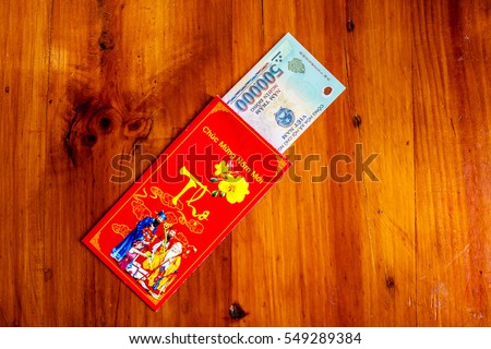 Habit, custom of Vietnamese on Tet is lucky money, a Vietnam traditional culture, child wish somebody a happy new year, receive red envelope with new small change, Tet on spring, also lunar new year