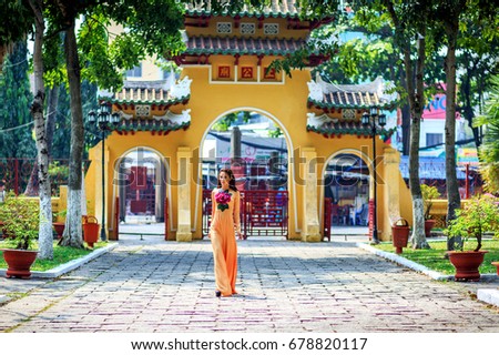 HO CHI MINH, VIETNAM - MAY 10, 2016: Vietnamese girl traditional dress, " Ao dai " is famous traditional costume for woman in Vietnam at pagoda