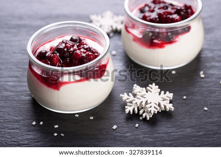 Jelly with berries in glass jar for christmas on dark background