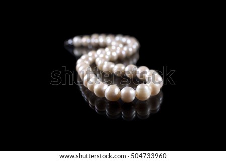 String of pearls on black background