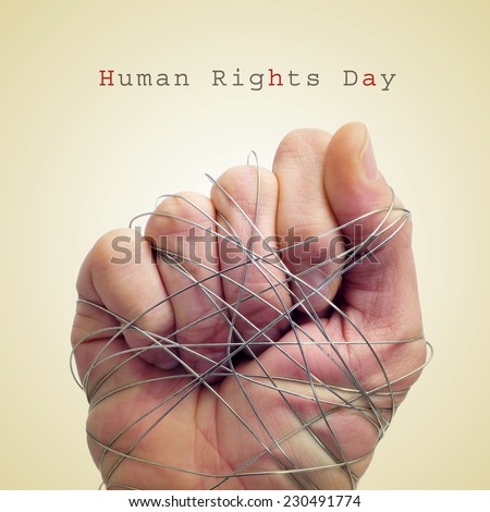 a man hand tied with wire and the text human rights day on a beige background