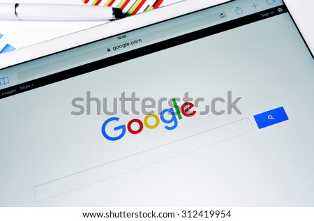 BARCELONA, SPAIN - SEPTEMBER 2, 2015: A tablet computer with the Google Web Search homepage in its screen with the new Google logo, launched in September 1
