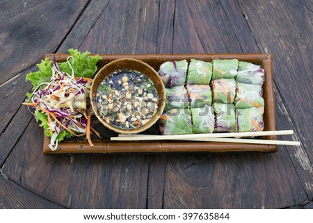 Fresh vietnamese spring rolls on a plate with salad