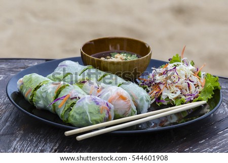 Fresh vietnamese spring rolls on a plate with salad