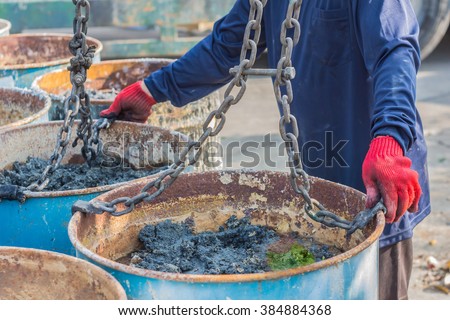 Transport workers are carrying sludge treatment system through a rolled sheet to take to eradicate the plant.