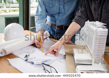 Image of engineer meeting for architectural project. working with partner and engineering tools on workplace