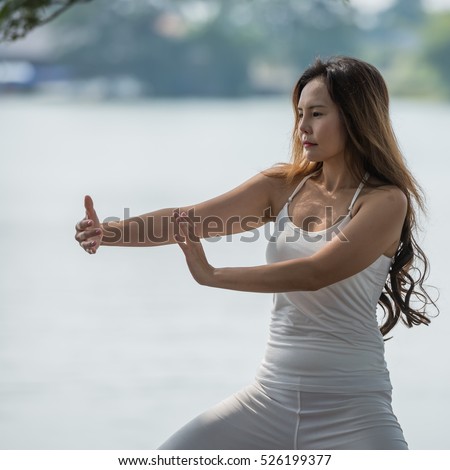 https://thumb1.shutterstock.com/display_pic_with_logo/3558143/526199377/stock-photo-young-woman-practicing-tai-chi-or-martial-arts-prepare-for-fighting-in-the-park-526199377.jpg