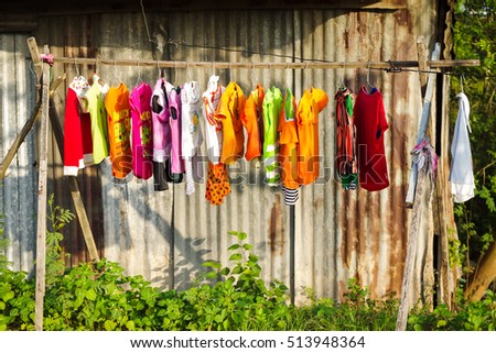 Dong Nai, Vietnam - December 22, 2013: Drying colorful baby's clothes in daylight beside countryside road