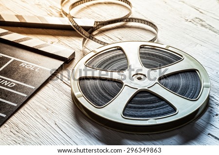 Film camera chalkboard and roll on wooden table