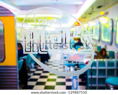 Valencia, Spain - December 3 , 2016: Tommy Mel's restaurant crystal door, with its logo