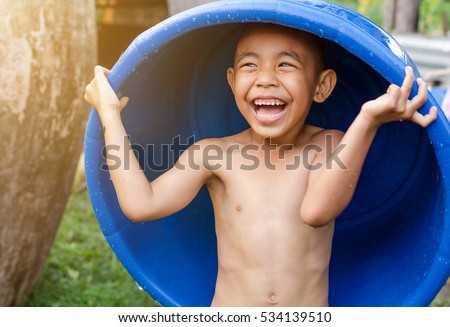 Little boy asia good mood playing water bathing in a basin