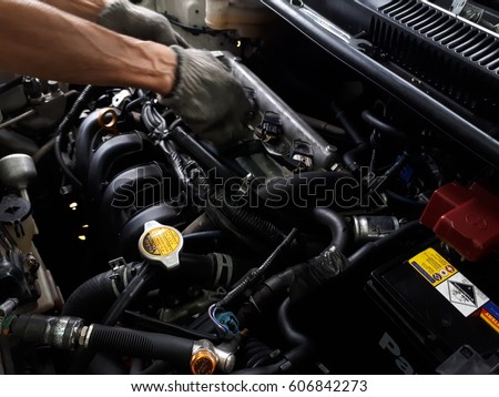 The mechanic is repairing the car.