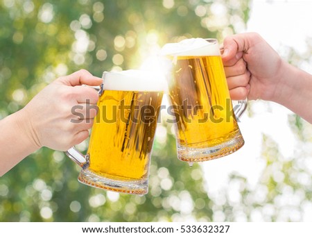 stock-photo-clinking-beer-glasses-on-blu