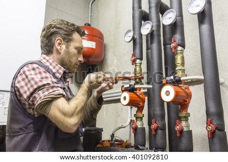 plumber at work installing a circulation pump