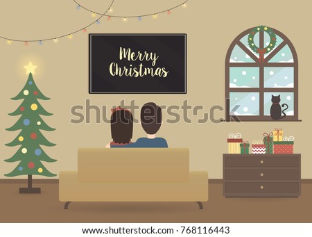 young couple watching tv in a christmas decorated interior of a house holidays decoration in - Christmas Tv Decoration young couple watching tv in a christmas decorated interior of a house holidays decoration in - Christmas Tv Decoration