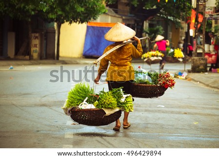 Women selling flowers in the early morning in a small market, Hanoi, Vietnam. Life of florist vendor in Hanoi, Vietnam.
