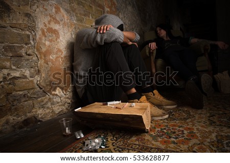 Drug addict man and woman sleeping after using different types of drugs. People resting after using heavy drugs. No to drugs concept.
