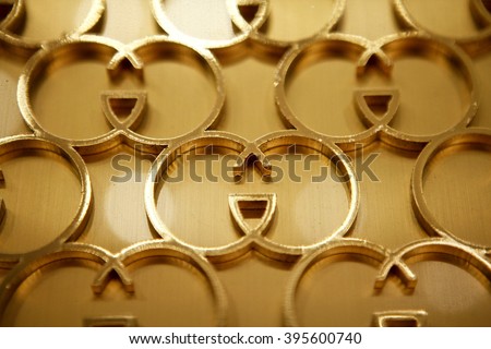 ROME, ITALY - 19 NOVEMBER 2012: Interlocking "G" Gucci logos form a display on a wall inside a Gucci store.