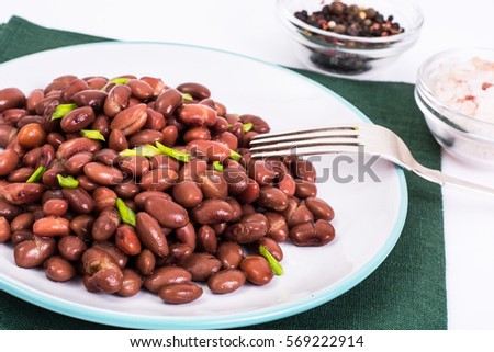 Spicy dish of red beans with green onions and spices. Studio Photo