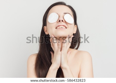 Woman cotton pads on the eyes..