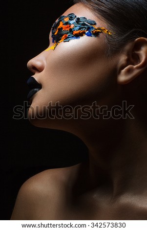 Portrait of the beautiful asian girl with creative art makeup with bright colors