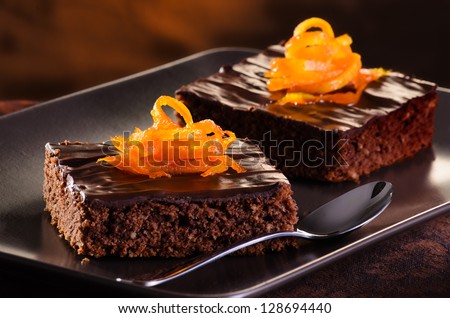 Homemade Chocolate Brownie on a dark plate against a dark background - stock photo