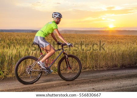 https://thumb1.shutterstock.com/display_pic_with_logo/369524/556830667/stock-photo-young-woman-on-the-mountain-bike-girl-riding-bicycle-on-the-road-walk-on-the-bike-in-nature-556830667.jpg