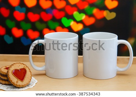 two white mugs cookies near them stock photo 387534343 shutterstock