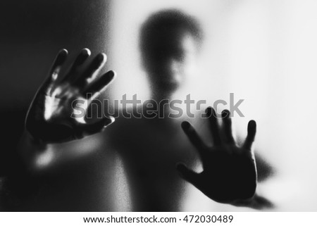 Ghosts hand silhouette behind the glass Ghosts hand silhouette behind the glass
