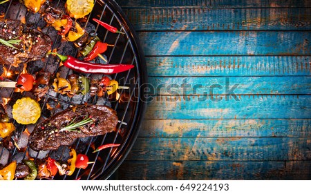 Barbecue garden grill with beef steaks, close-up.