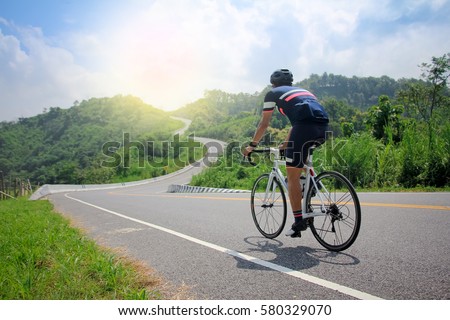 Men cycling mountain road bike in the morning