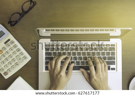 Top view of young woman sitting on floor with laptop