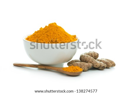 Bowl of turmeric powder with fresh turmeric root