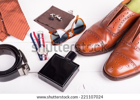 Man's style, urban shoes, socks and accessories on wooden table