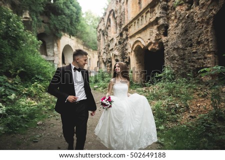 stock photo beautiful romantic wedding couple of newlyweds hugging near old castle 502649188