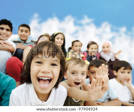 Crowd of children, different ages and races in front of the school, breaktime