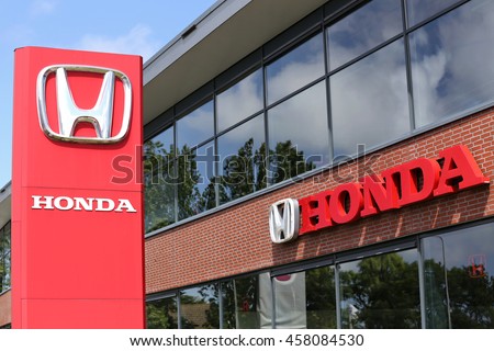 NOORDWIJK, THE NETHERLANDS - July 3, 2016: Honda dealership sign in front of the showroom. Honda is the second-largest Japanese automobile manufacturer.