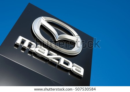 GUMMERSBACH, GERMANY - October 30, 2016: Mazda dealership sign against blue sky. Mazda is a Japanese automaker and produces over 1 million vehicles per year.