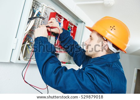 electrician examining current voltage with screwdriver tester