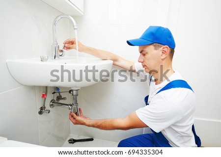 plumber man repair leaky faucet tap