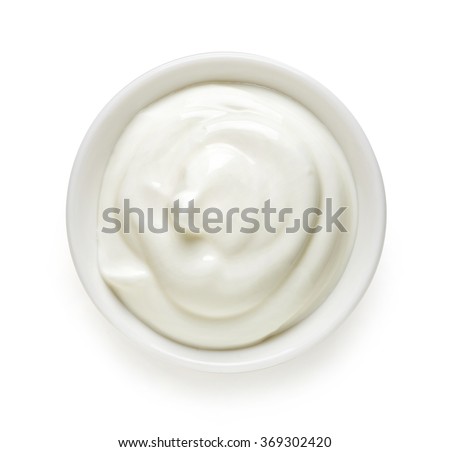 Bowl of cream on white background, top view