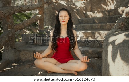 Young girl doing yoga fitness exercise outdoor in beautiful mountains landscape. Morning sunrise. Meditation and Relax.Woman practicing yoga on the beach at sunset. Yoga woman mountain peak