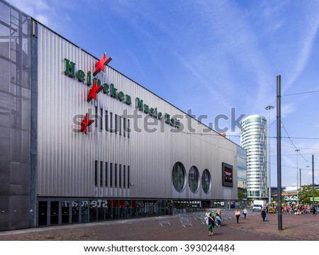 Amsterdam, Holland, June 24, 2014: Facade of the Heineken Music Hall with people on the Arena Boulevard, during daytime