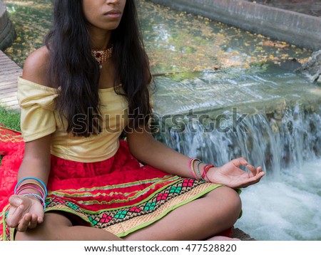 https://thumb1.shutterstock.com/display_pic_with_logo/4000867/477528820/stock-photo-hindu-woman-meditating-in-the-park-in-yoga-posture-with-mudra-hands-position-477528820.jpg